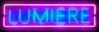 Lumiere in blue neon, in a pink neon rectangle